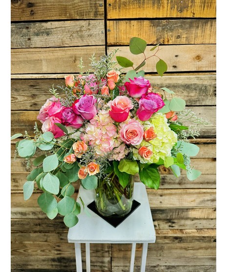 Pretty Pastel - Elegant greenry embraces pastel roses and hydranges in a clear glass vase,