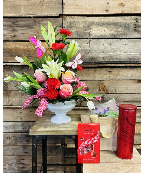 pink lilies, red roses, and hydrangeas in dramatic bohemian style floral arrangement