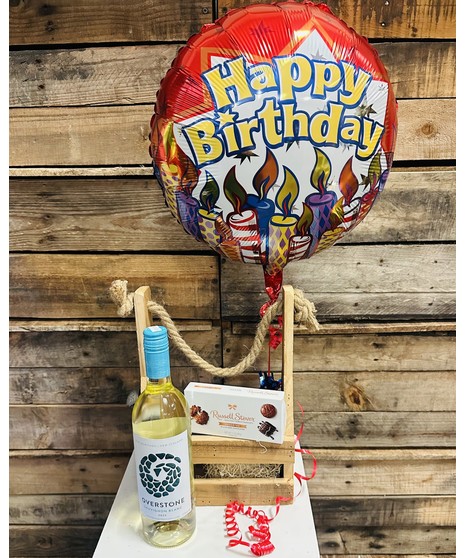 bottle of wine with chocolates and smiley face balloon